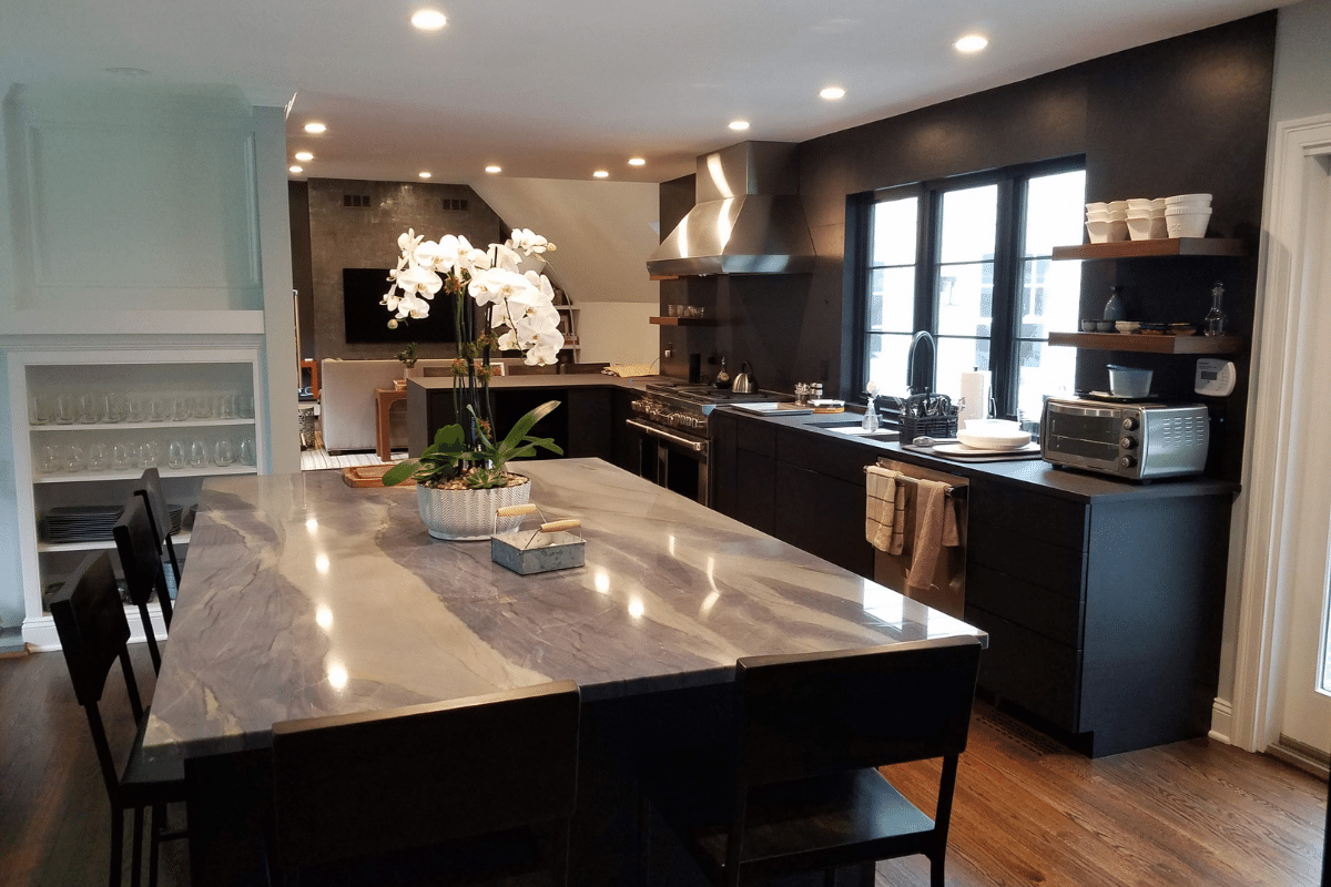 matte black kitchen with black walls and white granite countertop