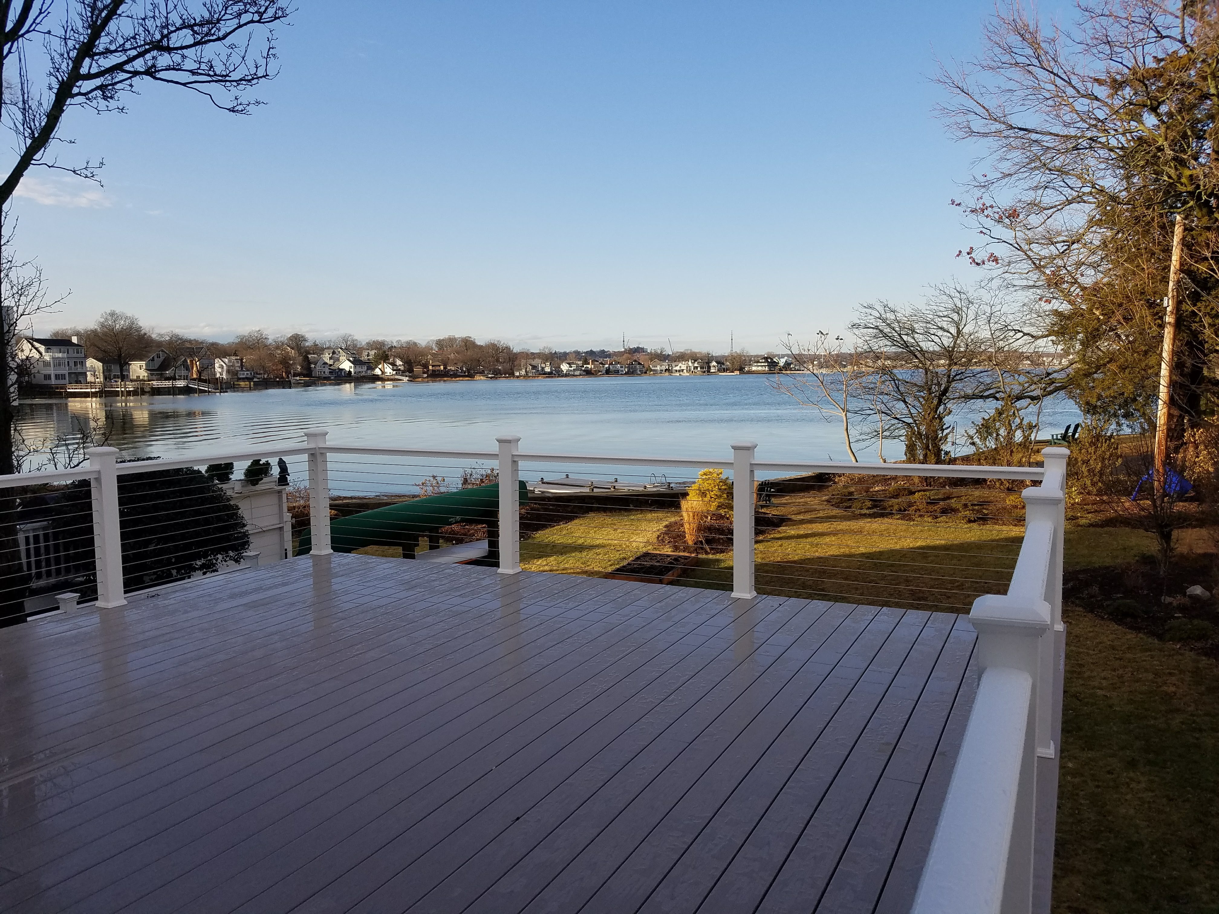 large open deck with fence overlooking lake view