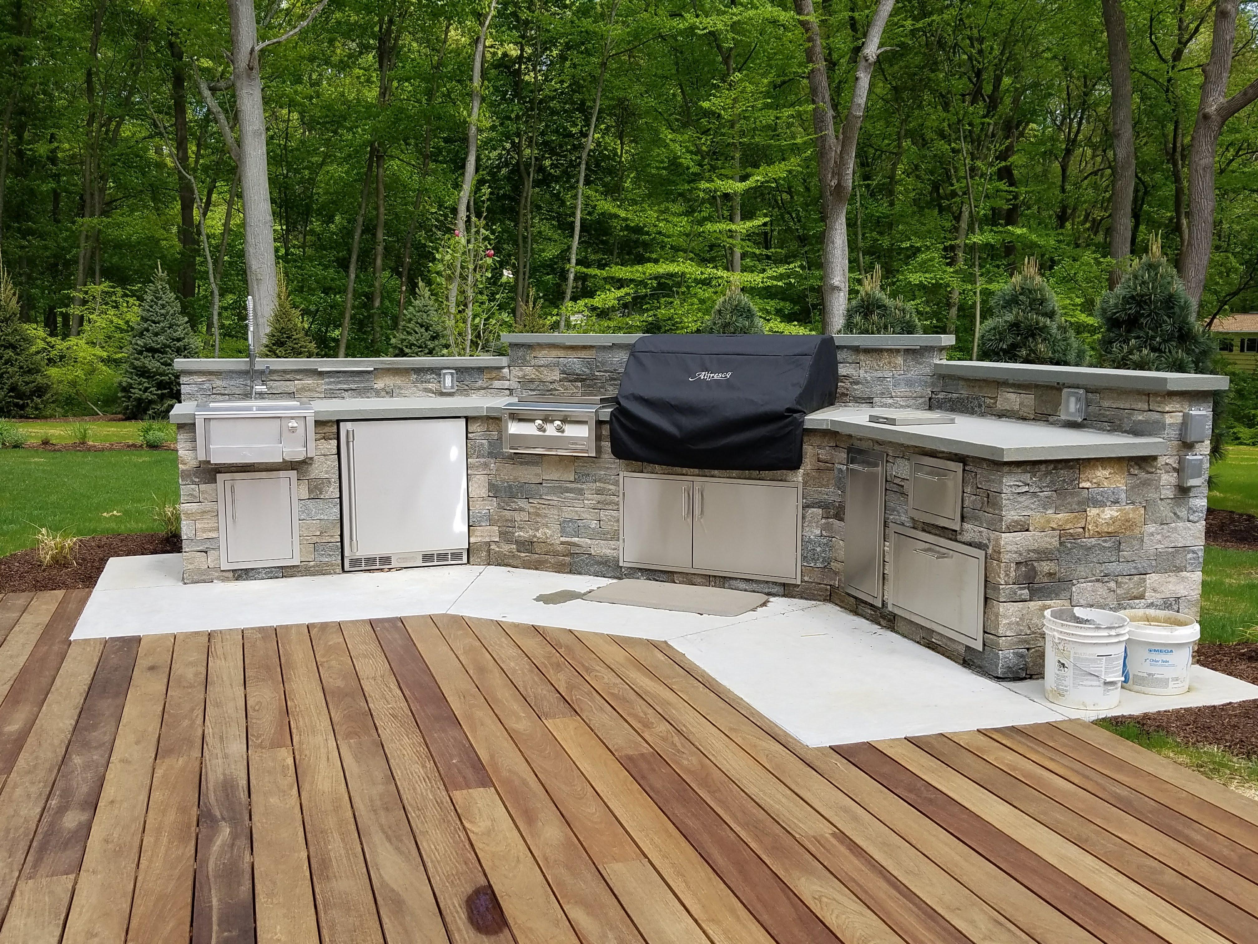 outdoor kitchen with large grill and wood deck