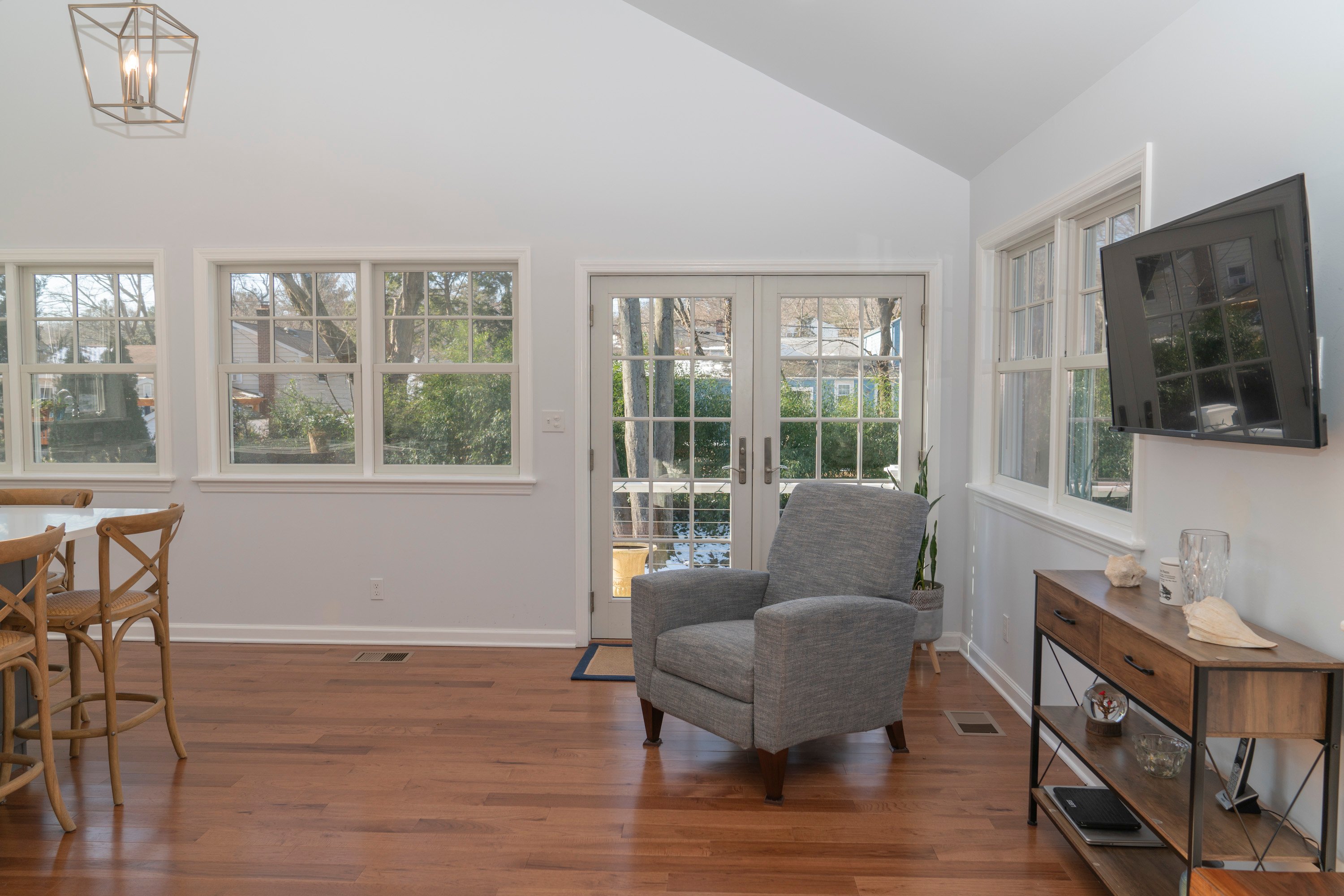 brown wood flooring in kitchen with white walls