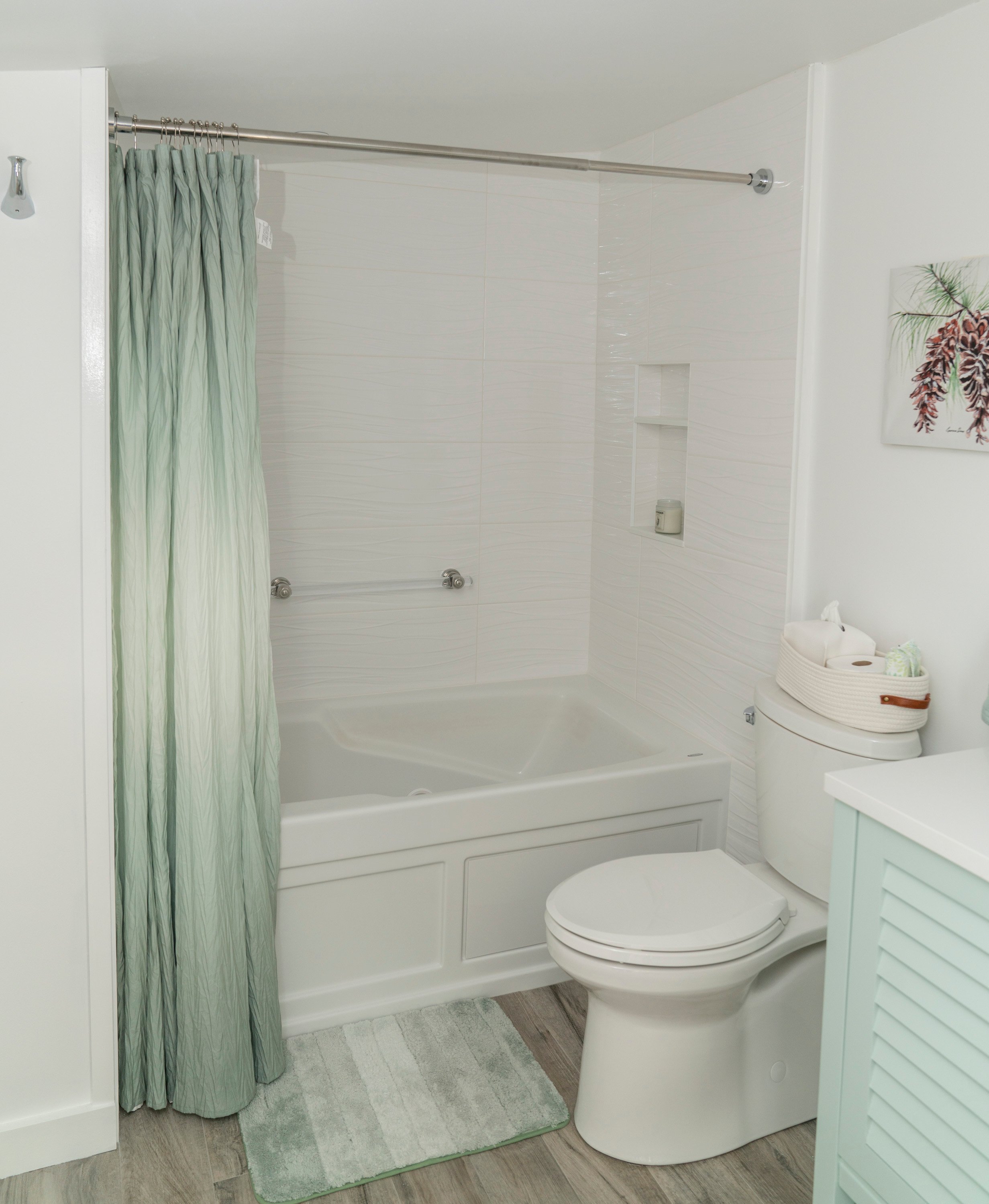 white light bright bathroom with green shower curtain