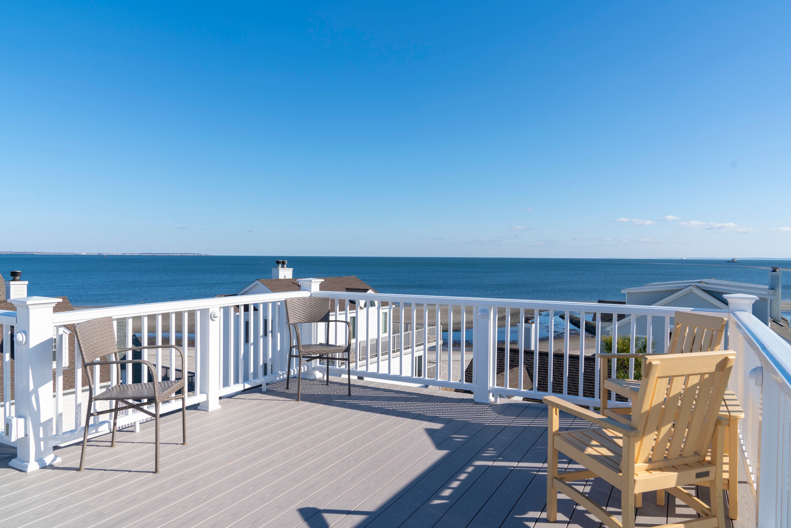 rooftop deck with chairs overlooking beach area