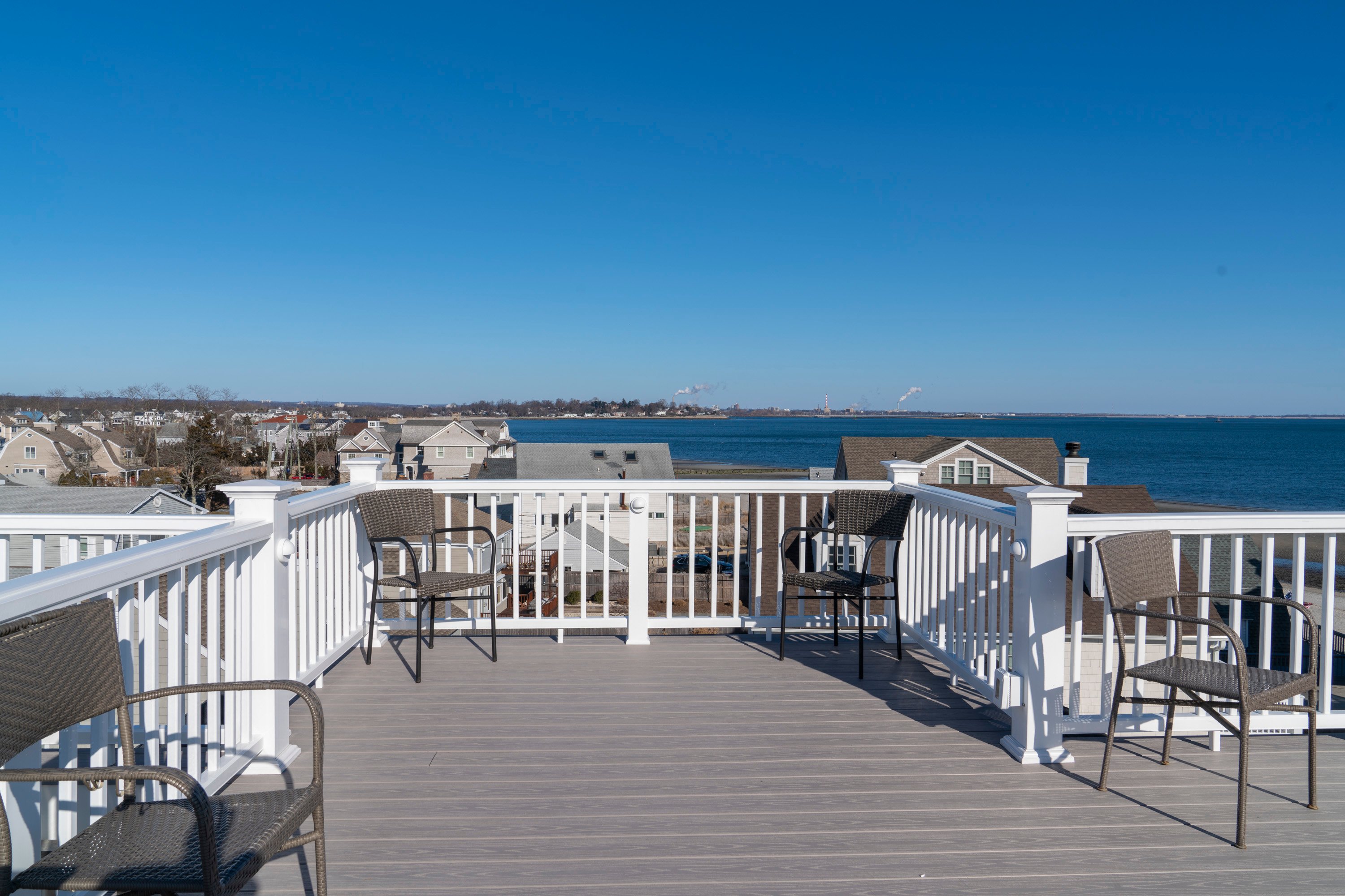 rooftop deck with chairs overlooking beach area