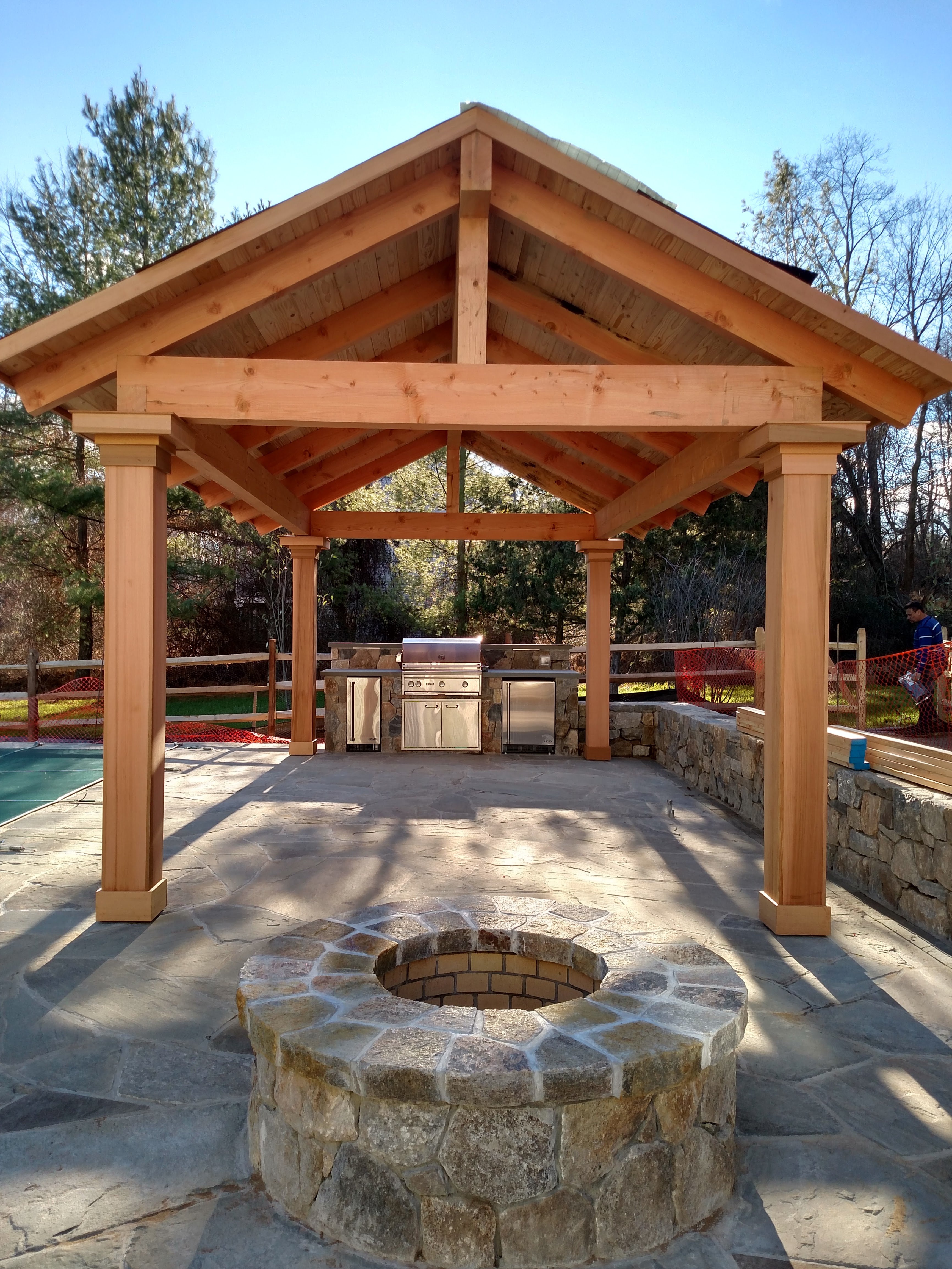 wood cover area with fire pit and room for outdoor seating