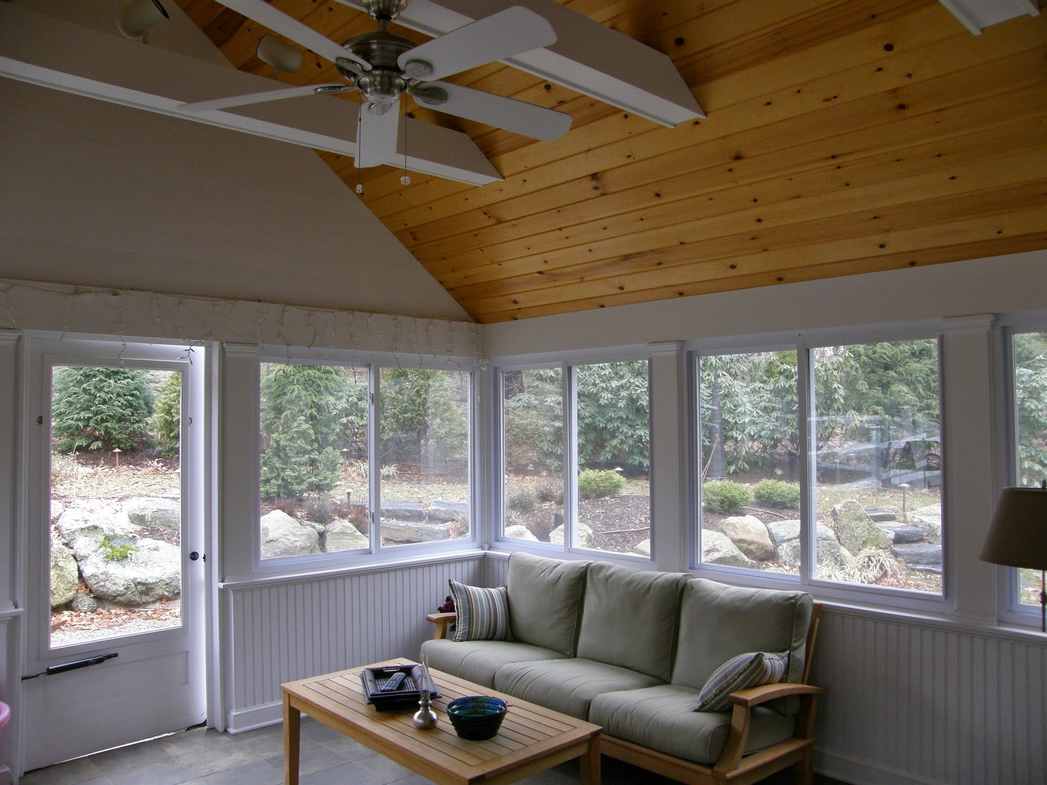 sunroom addition with tons of natural lighting and ceiling fan