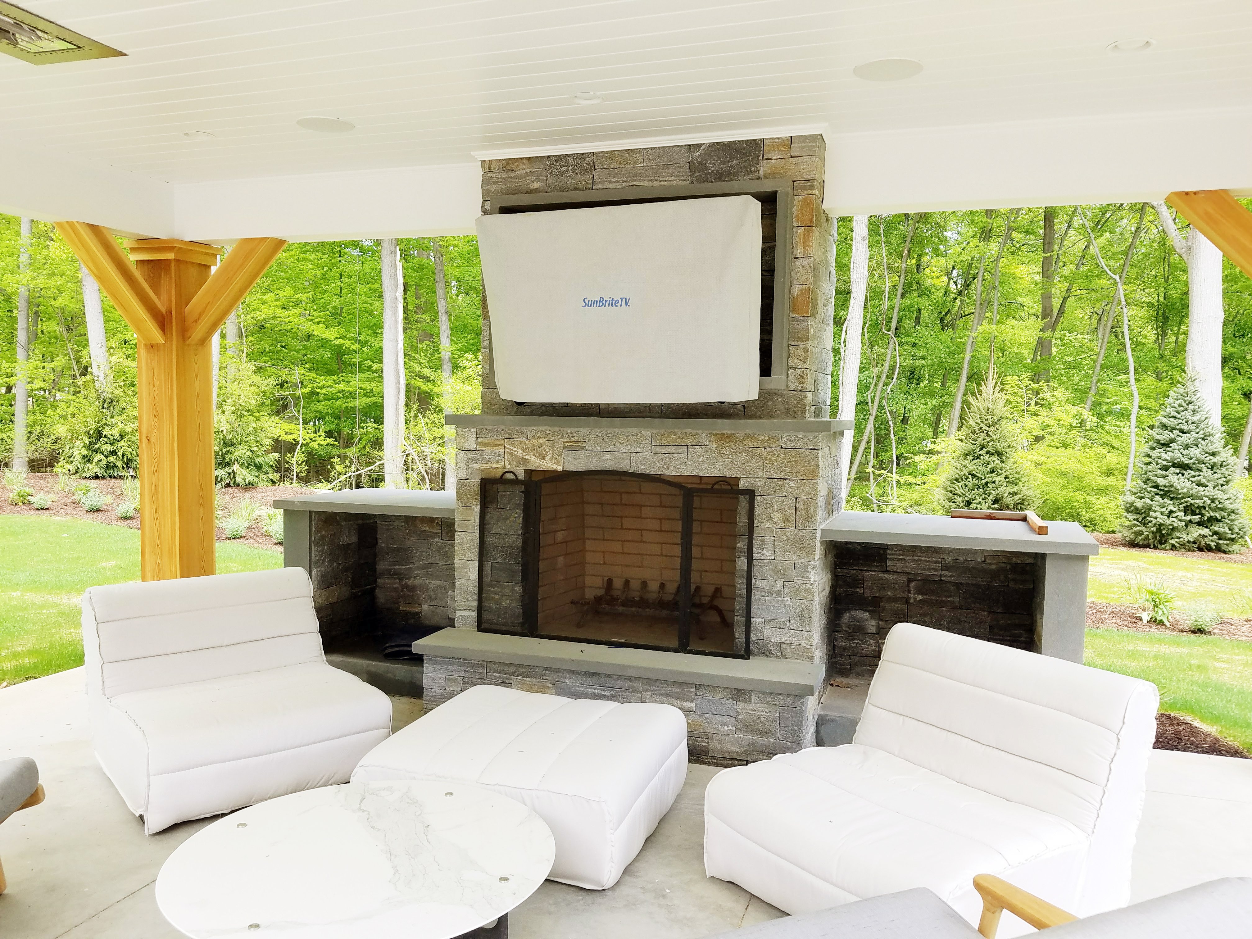 outdoor seating with mounted tv and fireplace